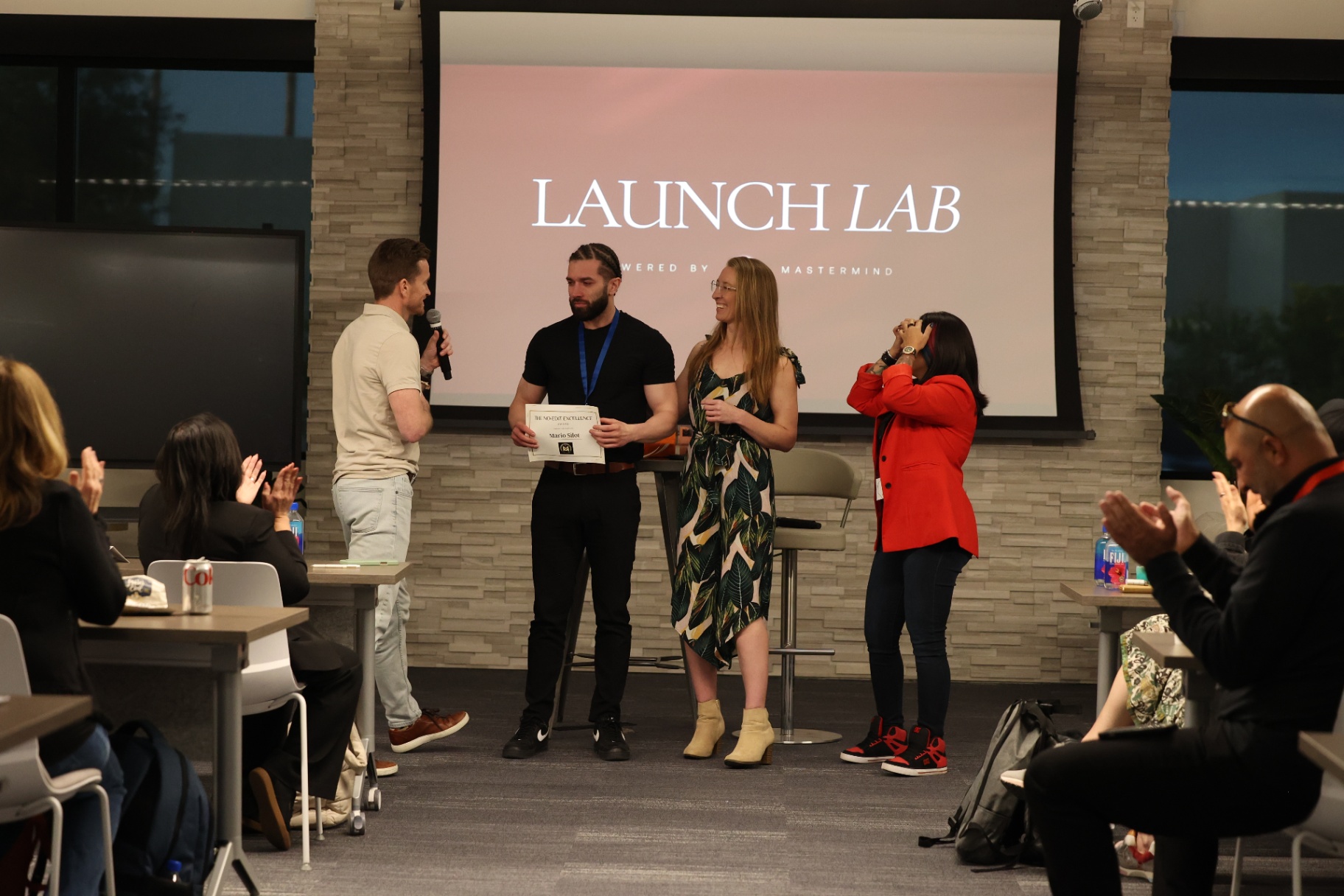Mario Silot receiving recognition on stage at Launch Lab