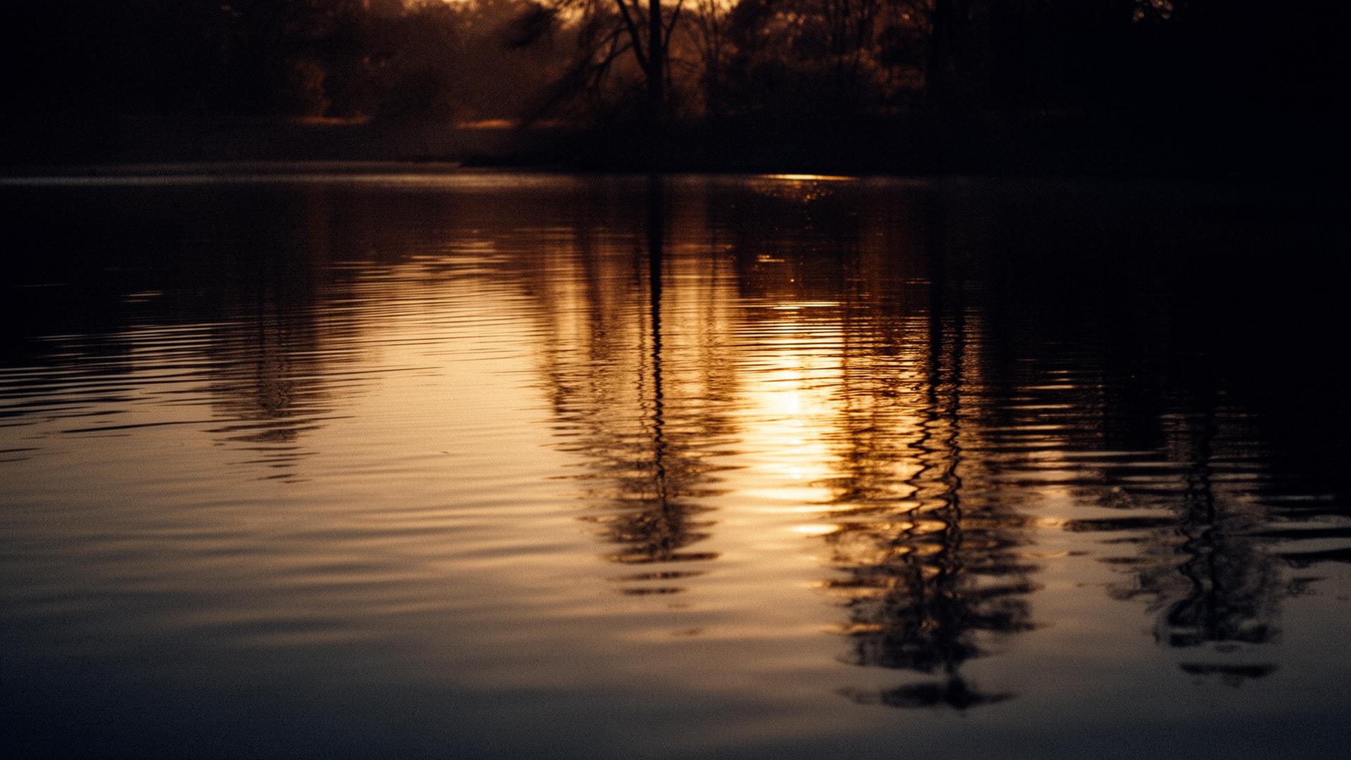 Still water at dusk reflecting golden light